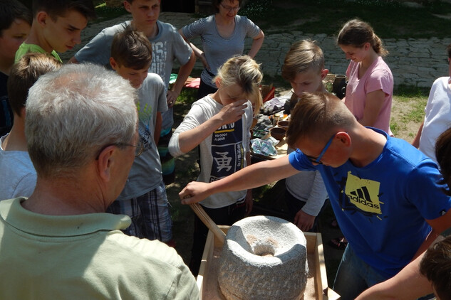 Edukační program na hradě Lipnice, mletí pšenice na kamenném mlýnku